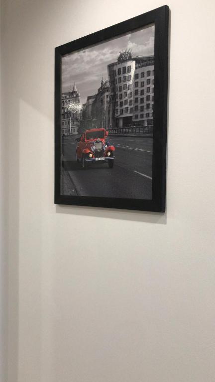 a picture of a red car on a wall at Apartament Nowodworska in Elblag