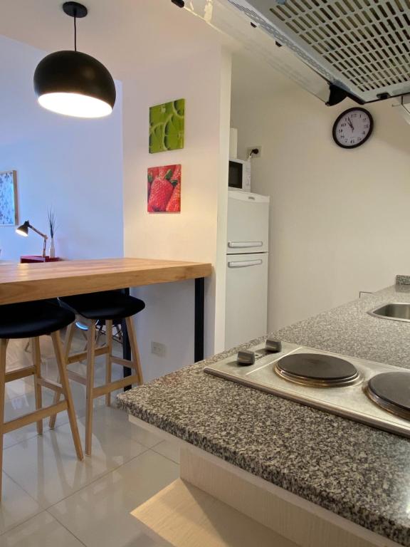 a kitchen with a table and a counter top at Penguins Flats 5 in Ushuaia