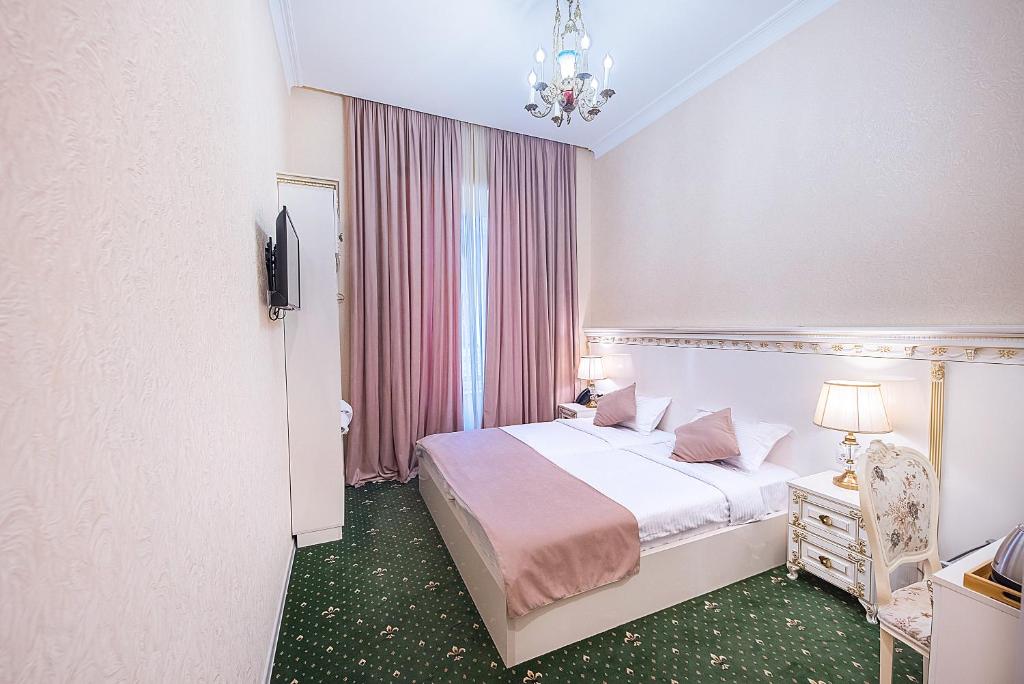 Postel nebo postele na pokoji v ubytování Vintage Hotel