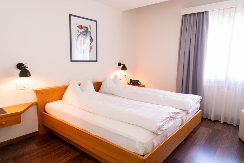 Postel nebo postele na pokoji v ubytování Hotel Schatzmann