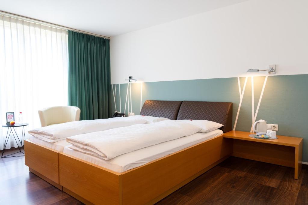Postel nebo postele na pokoji v ubytování Hotel Schatzmann
