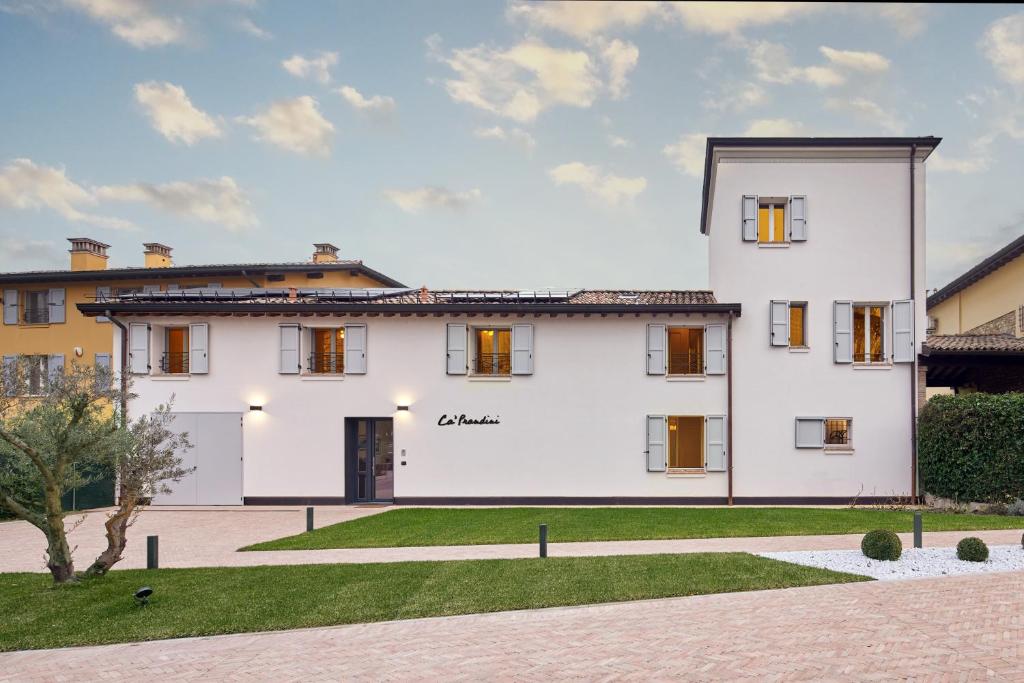 a large white house with a courtyard at Ca’ Prandini in Maranello