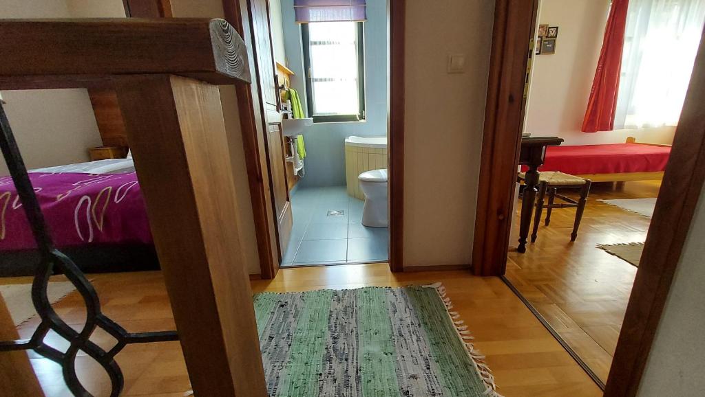Postel nebo postele na pokoji v ubytování Titi Family Apartman