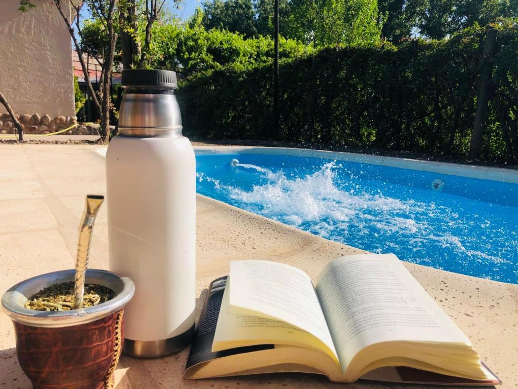 a bottle of milk and an open book on a table at La Casona de Don Salo in Mendoza