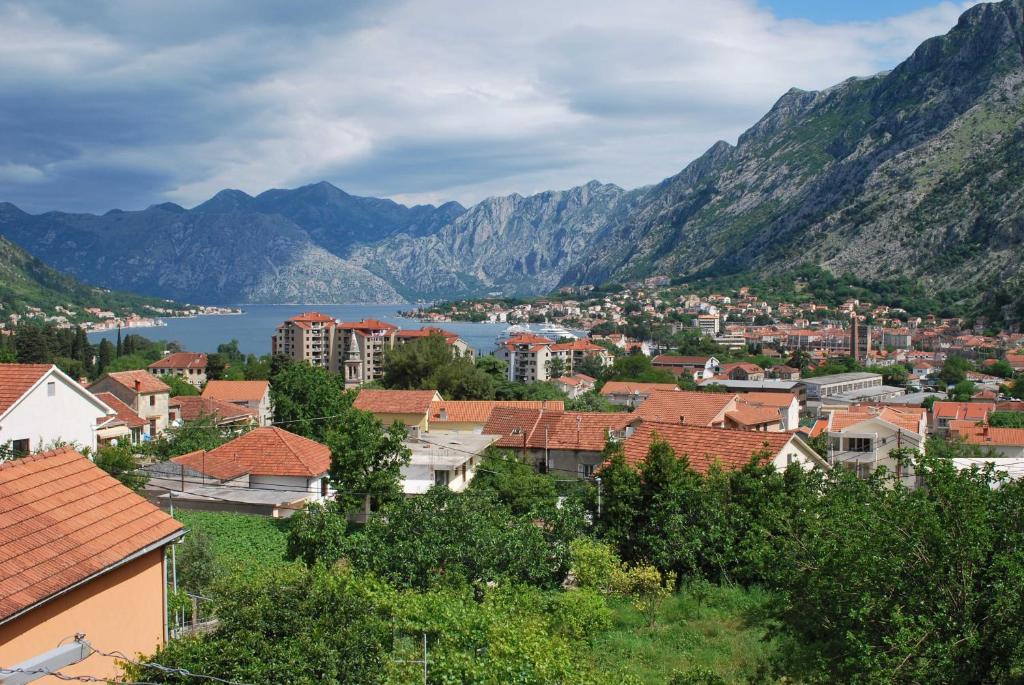 a town in the mountains with a body of water at Guest House Sandra in Kotor