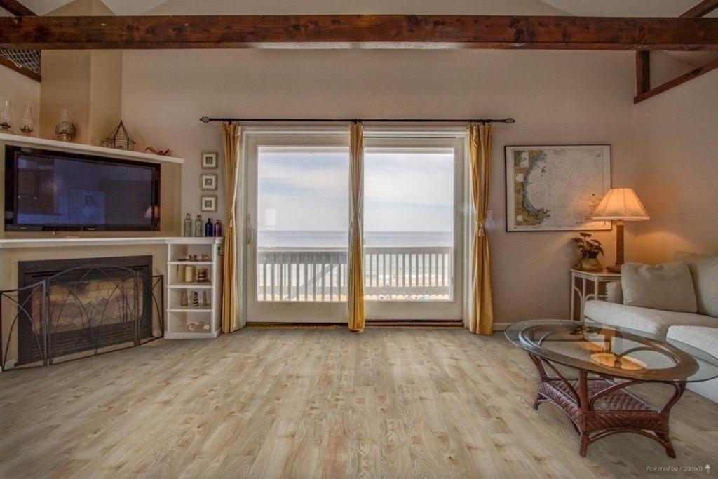a living room with a view of the ocean at Oceanfront Penthouse with Family & Friends in Salisbury