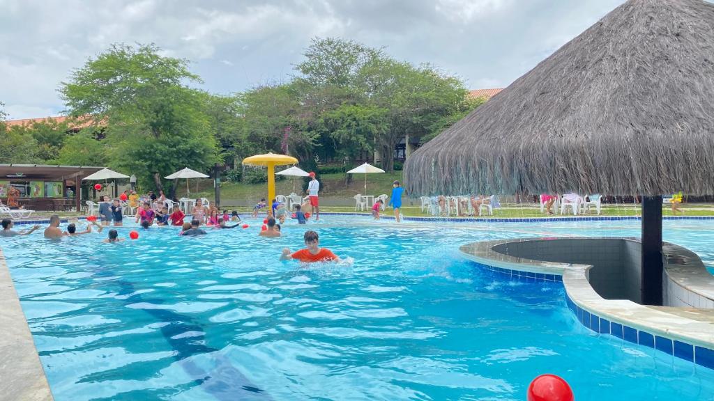 a group of people swimming in a swimming pool at Gravatá - Apartamento Família no Monte Castelo in Gravatá