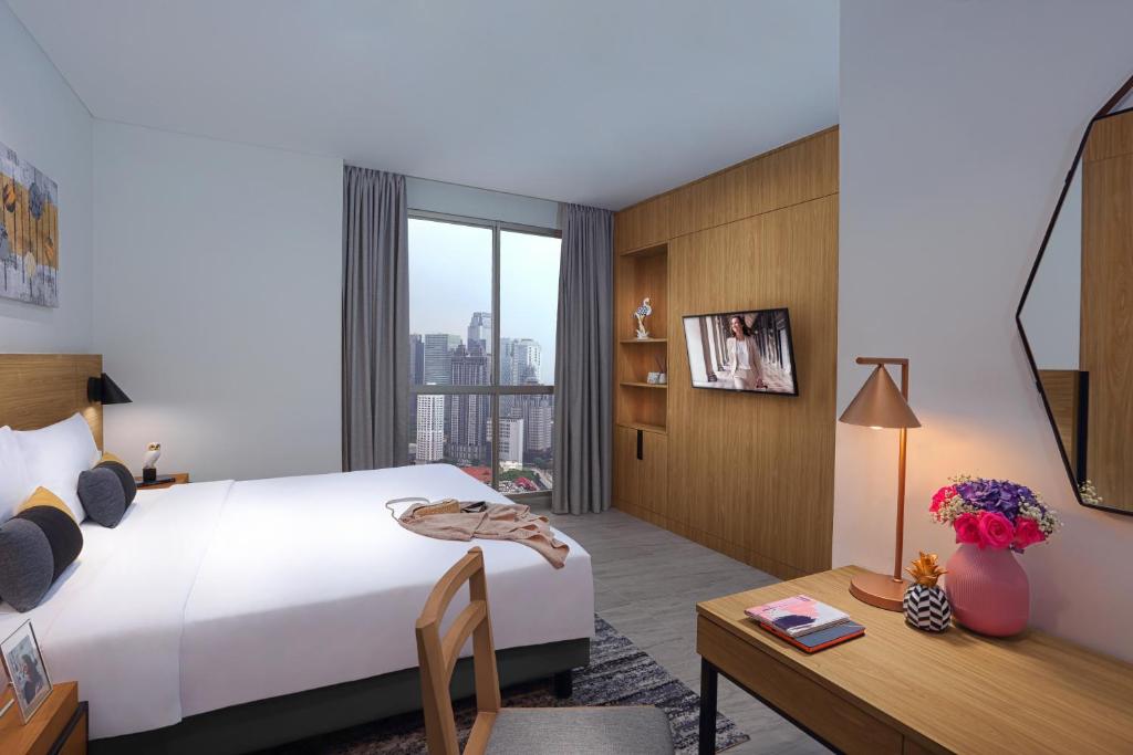 Postel nebo postele na pokoji v ubytování Citadines Sudirman Jakarta