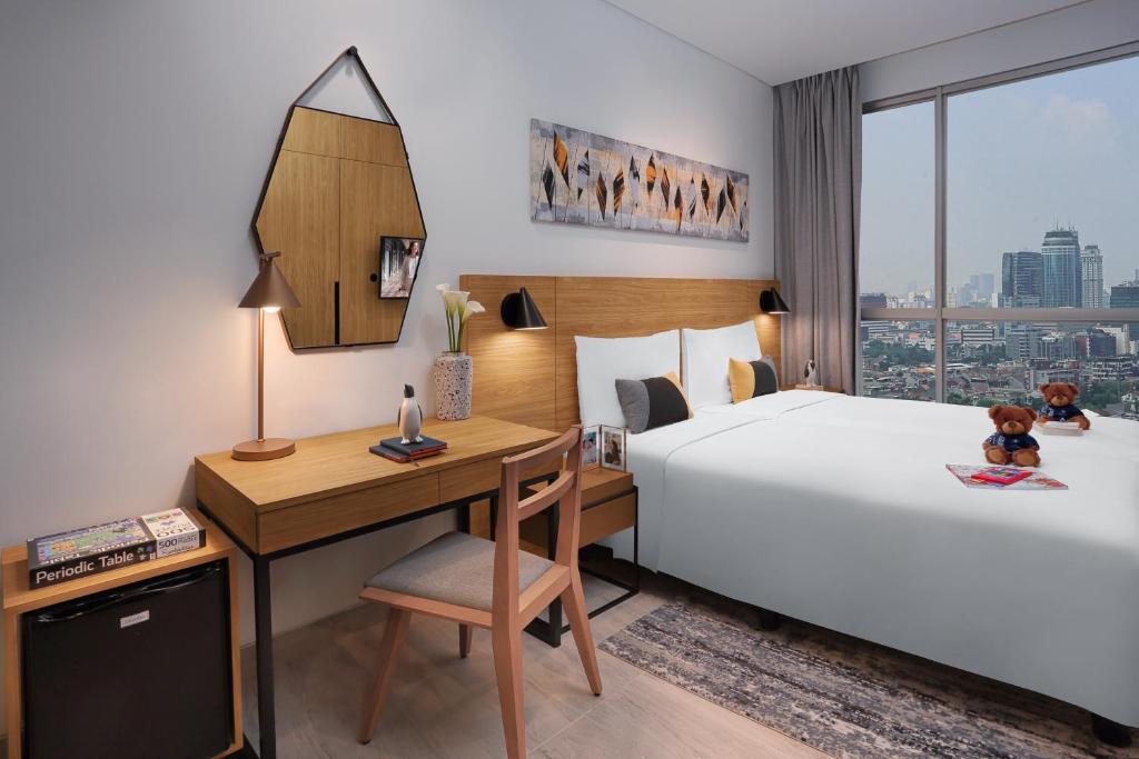 Postel nebo postele na pokoji v ubytování Citadines Sudirman Jakarta