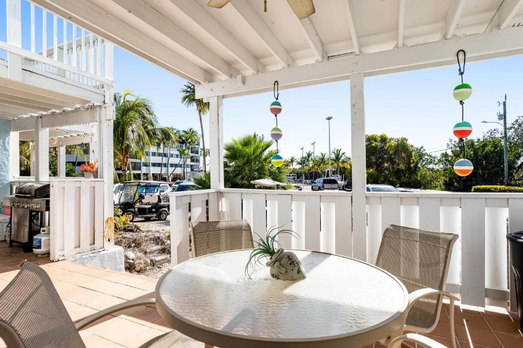 a patio with a table and chairs and a street at Kawama Yacht Club A4 in Key Largo