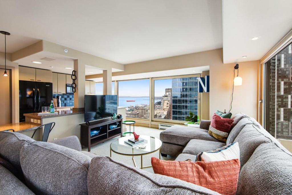 a living room with a couch and a large window at Newmark Tower II in Seattle