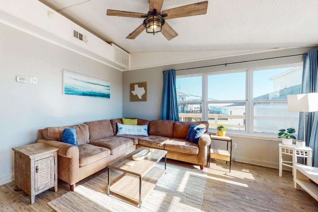 a living room with a couch and a large window at Sea It All in Freeport