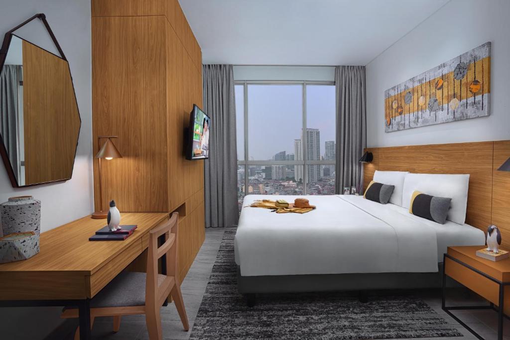 Postel nebo postele na pokoji v ubytování Citadines Sudirman Jakarta