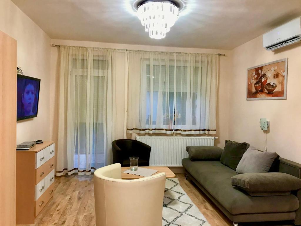 a living room with a couch and a table at Barki Apartman in Bük