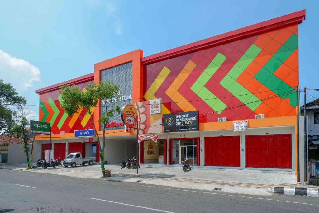um edifício com uma fachada colorida numa rua em RedDoorz Plus @ Jl Pemuda Pati em Pati