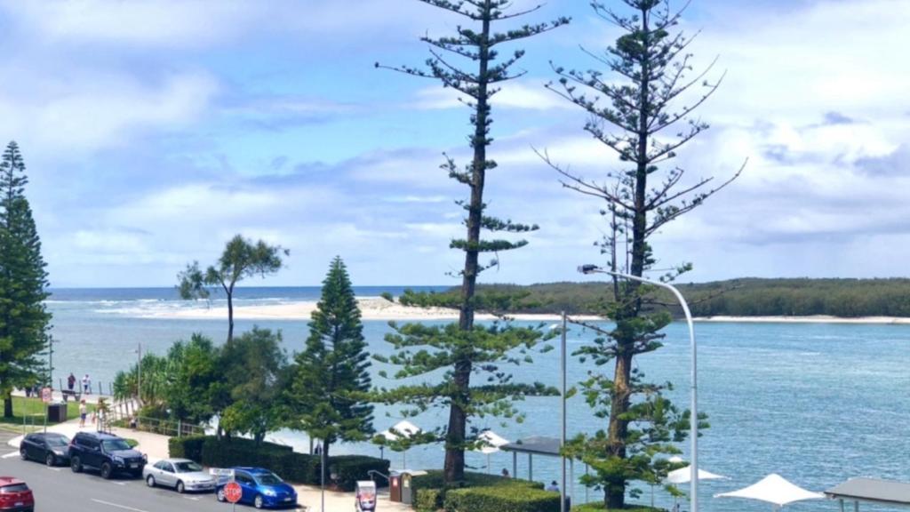 a view of a beach with cars parked in a parking lot at #55 Grand Pacific Resort, Outdoor Spa With A View! in Caloundra