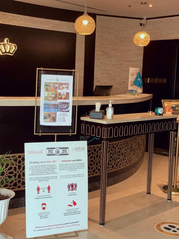 a sign in front of a table in a restaurant at Royal View Hotel in Ras al Khaimah