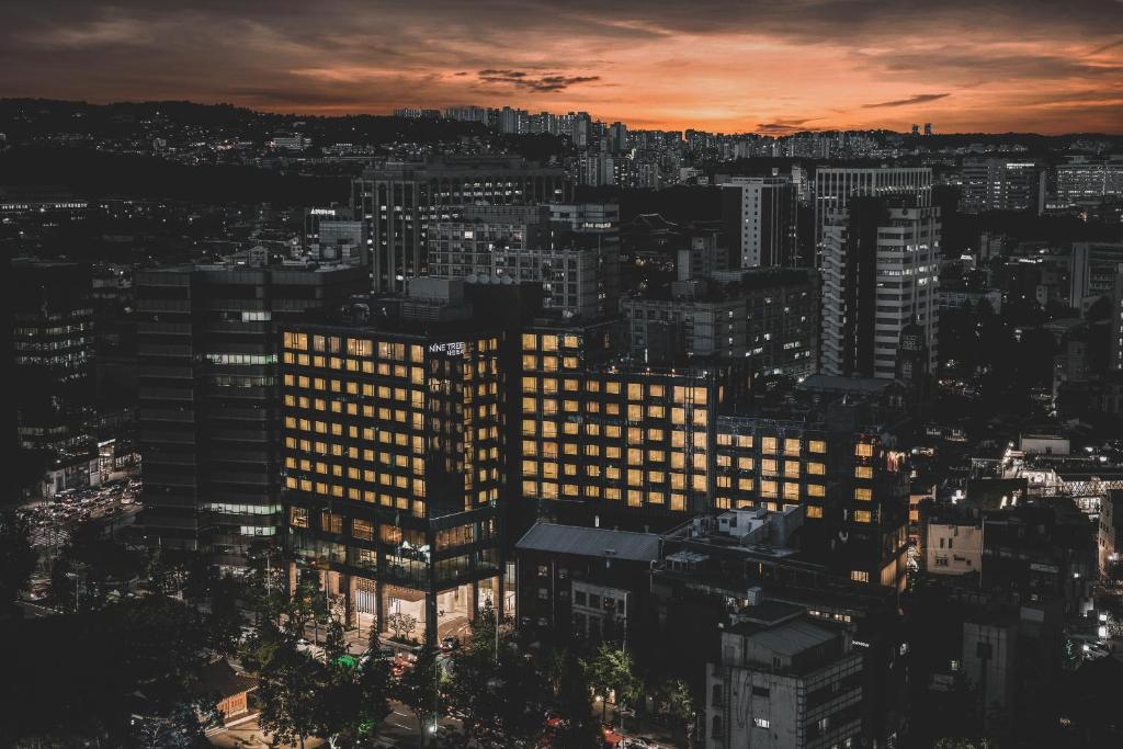 a view of a city at sunset at Nine Tree Premier Hotel Insadong Myeongdong in Seoul