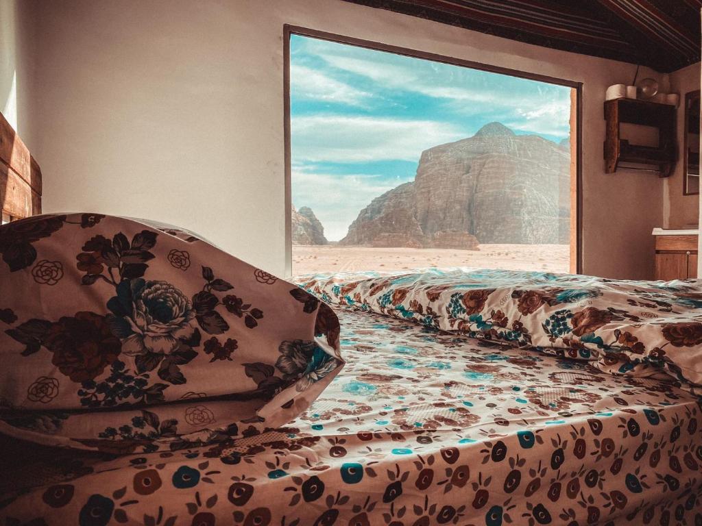 a room with a bed with a view of the desert at Martian desert Camp in Wadi Rum