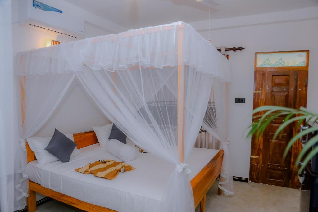 Postel nebo postele na pokoji v ubytování Ruwan Jungle Homestay