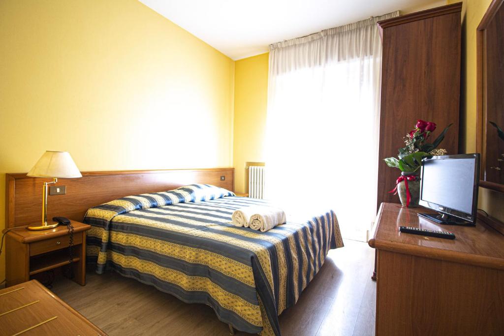 A bed or beds in a room at Hotel PRime - Montecatini