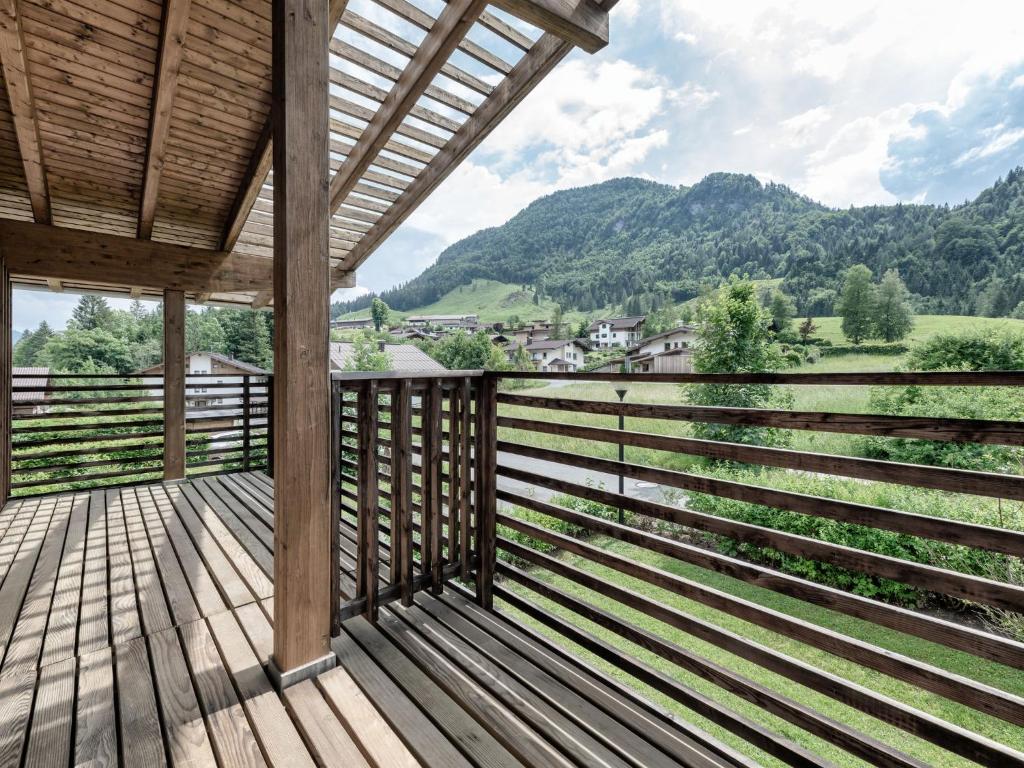a wooden porch with a view of a mountain at Urbane Apartment in Kirchdorf in Tirol near Ski Area in Kirchdorf in Tirol