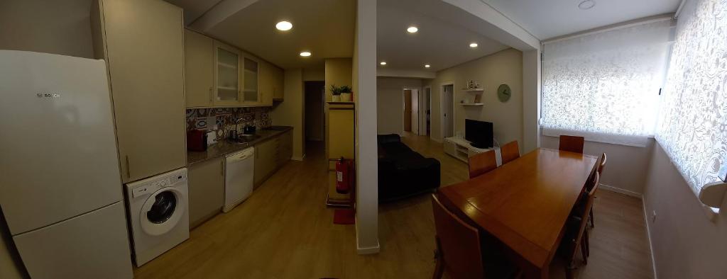 a kitchen and dining room with a table and a washing machine at Fish house Sesimbra in Sesimbra