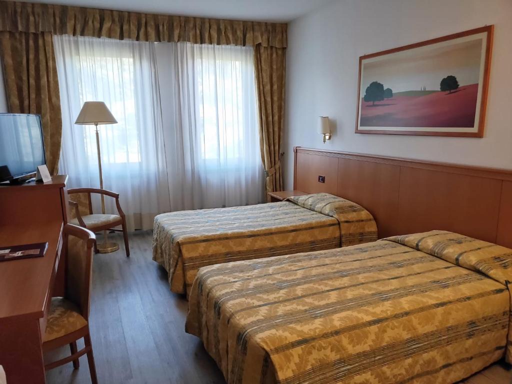 Postel nebo postele na pokoji v ubytování Hotel Galant