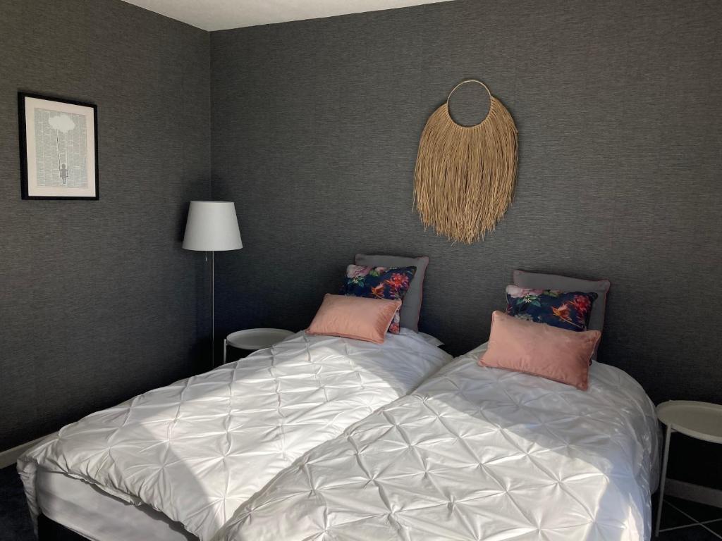 a bedroom with two beds and a wall at La Tuilerie Chambres d'Hôtes in Saint Die