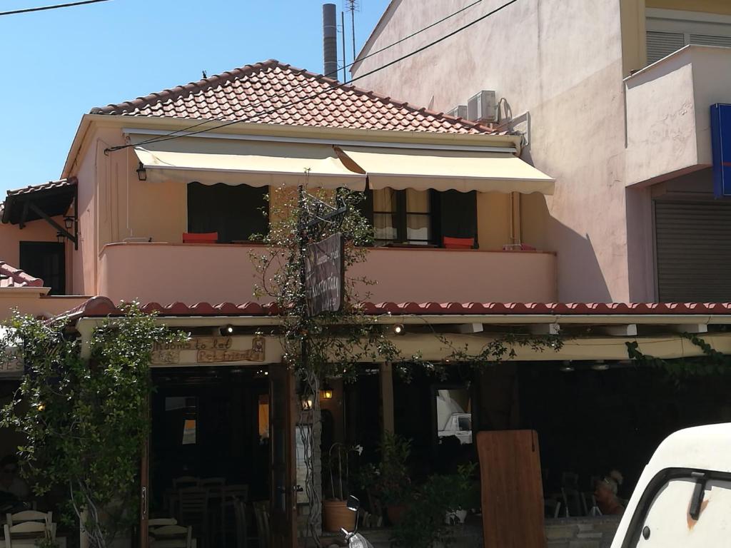 a building with an umbrella in front of it at Kostantaki Studios in Néa Péramos