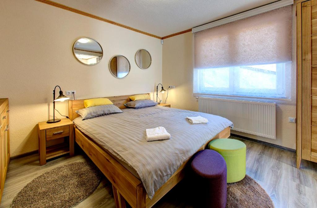 a bedroom with a large bed with two towels on it at Apartmani Di Casa Dreams in Donji Vakuf