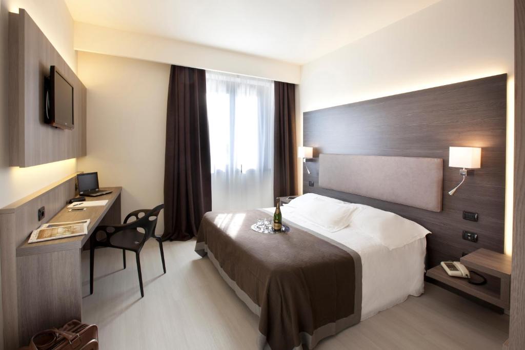 Una cama o camas en una habitación de Hotel Giardino