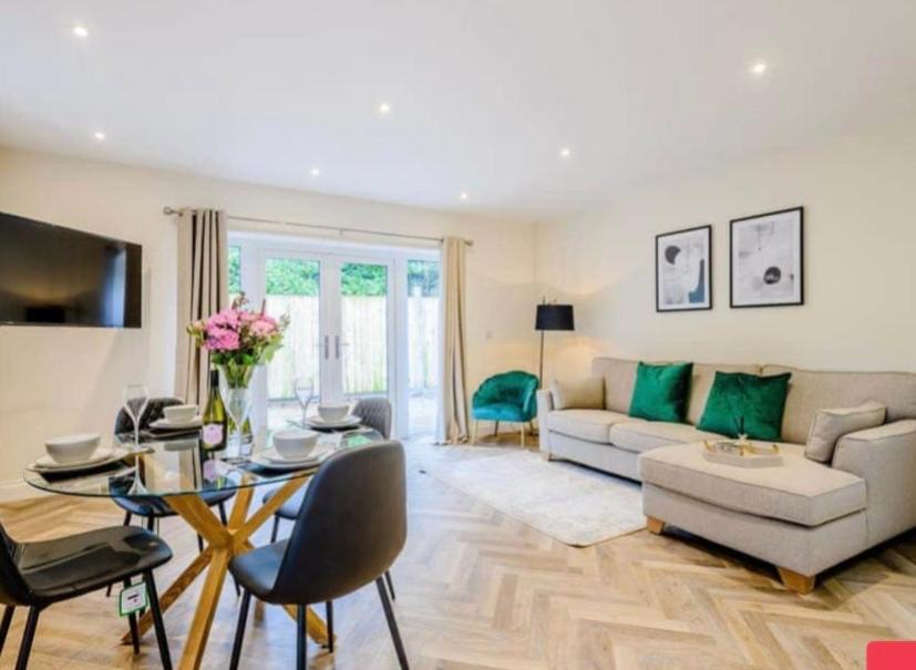 a living room with a couch and a table at The Lodge in Coltishall