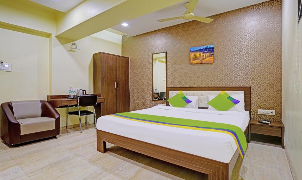 a hotel room with a bed and a desk at Treebo Trend De Grandeur Anand Nagar in Thane