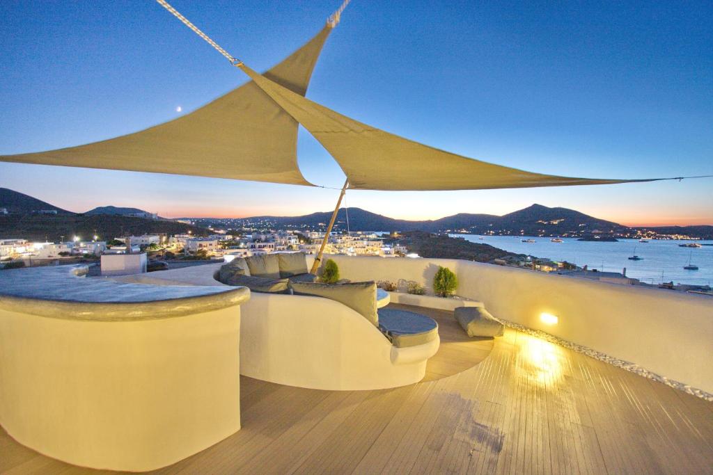 a rooftop bar with a view of the ocean at Yades Suites & Spa - Adults only in Naousa