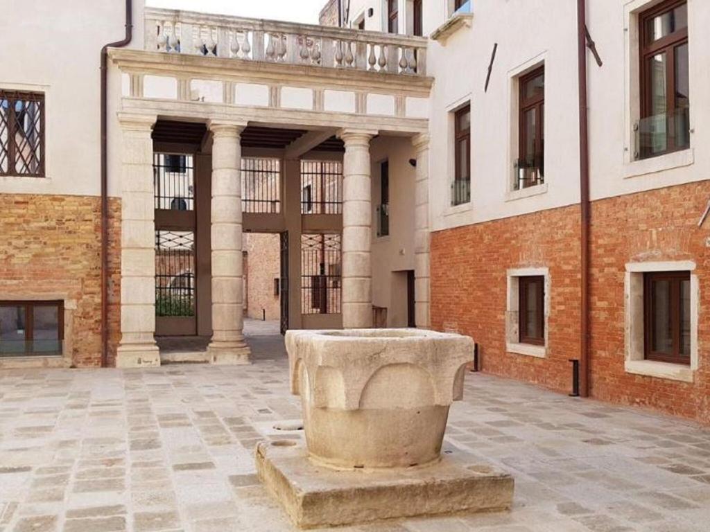 a stone statue in front of a building at Brand new boutique apartment in the heart of Venice in Venice