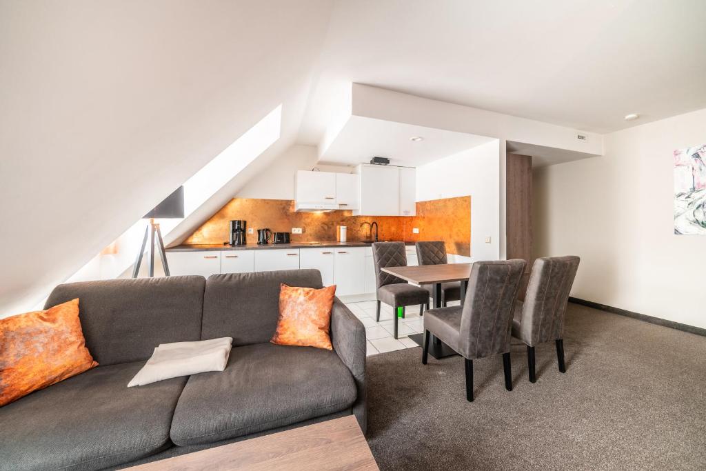 a living room with a couch and a table at Familienapartment Am Neumarkt ll in Dresden