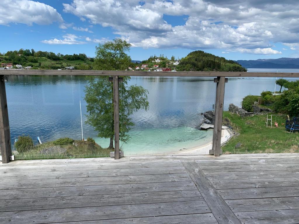 a view of a lake from a porch at Furrehytter in Sjernarøy