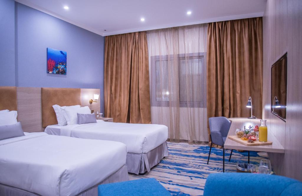 Voodi või voodid majutusasutuse Signature Guest Hotel فندق إمضاء النزيل الفندقية toas