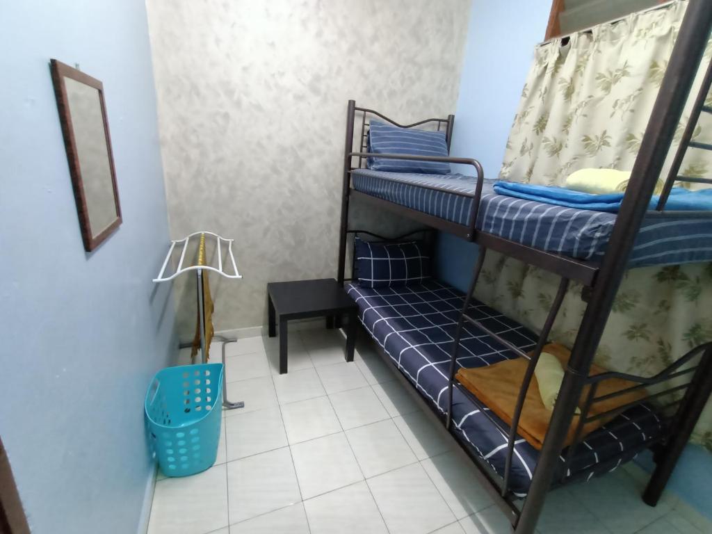 a room with two bunk beds and a lamp at SITI HOMESTAY D' TELOK KEMANG PORT DICKSON (MUSLIM HOMESTAY) in Port Dickson