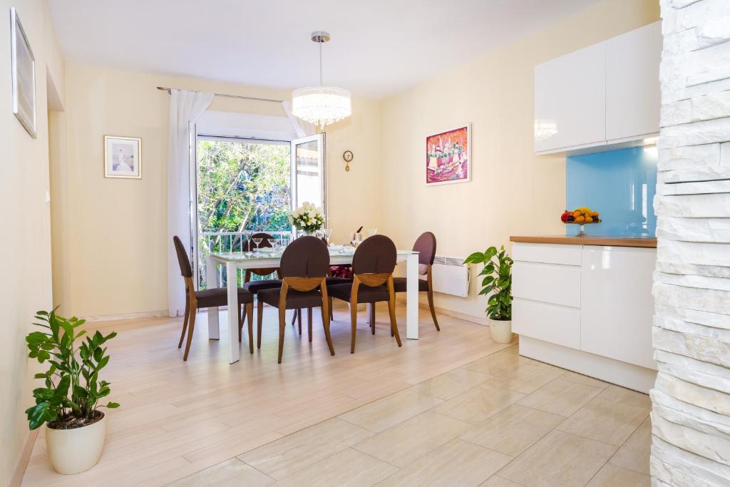a kitchen and dining room with a table and chairs at Exclusive Center Apartments in Zadar
