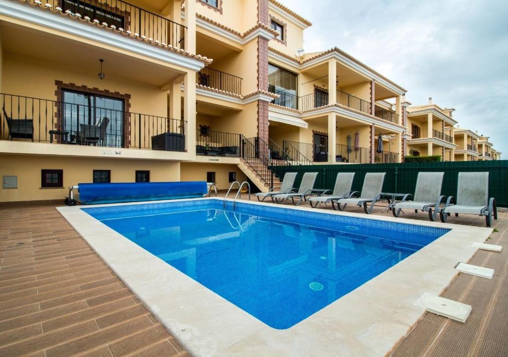 a swimming pool in front of a building at Algarve Luxury Home With Private Heated Pool II in Silves