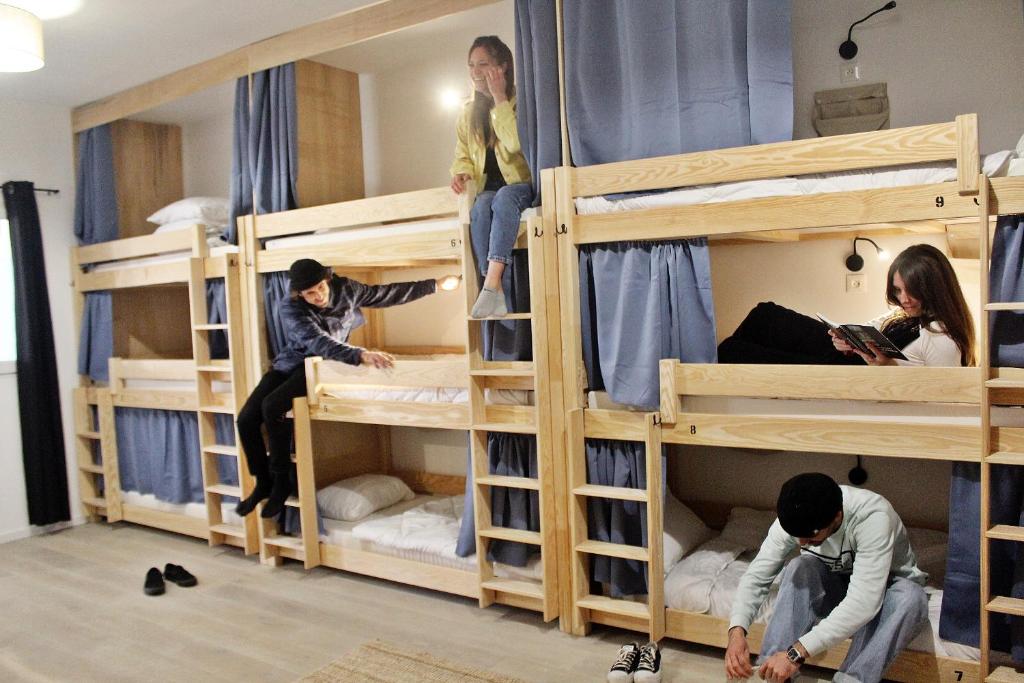 a group of people in bunk beds in a room at GARDEN - Utopy Hostel in Biarritz