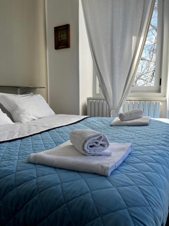 two towels on a bed in a bedroom at Villa Tergeste in Trieste