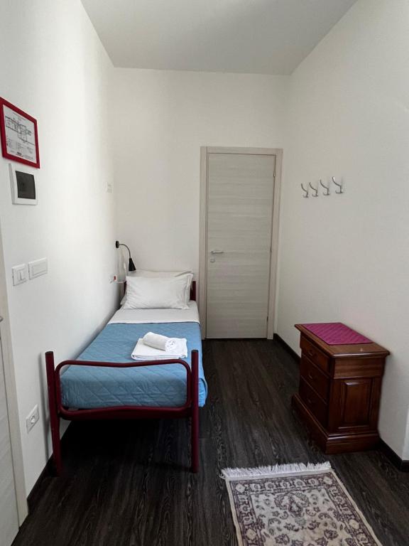 a small bedroom with a bed and a table at Villa Tergeste in Trieste