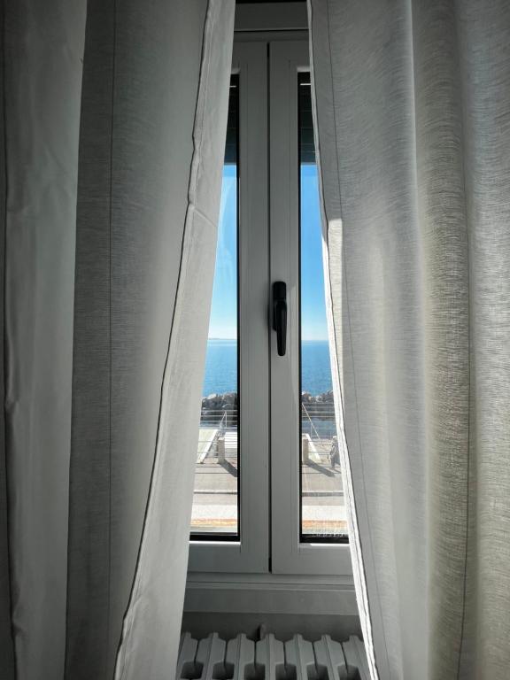 an open window with a view of the ocean at Villa Tergeste in Trieste