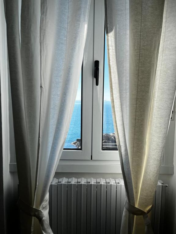 a window with a view of the ocean at Villa Tergeste in Trieste