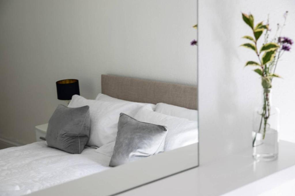 a mirror reflection of a bed with pillows in a bedroom at Whitecraigs in Elgin