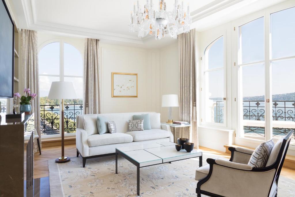 a living room with a couch and a table at The Woodward - an Oetker Collection Hotel in Geneva