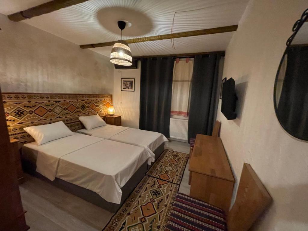 a bedroom with a bed and a table in a room at Hotel Casa Romaneasca in Otopeni